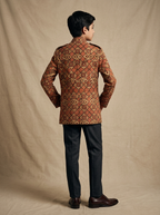 Boy wearing brown beige geometric hand block printed cotton shacket with mandarin collar back view