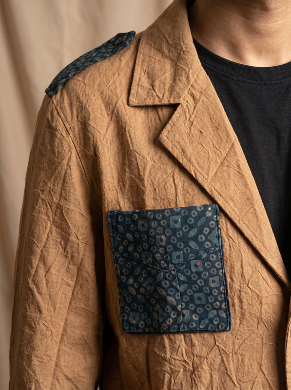 Boys camel shacket — close-up of indigo block printed pocket flap and epaulette detail