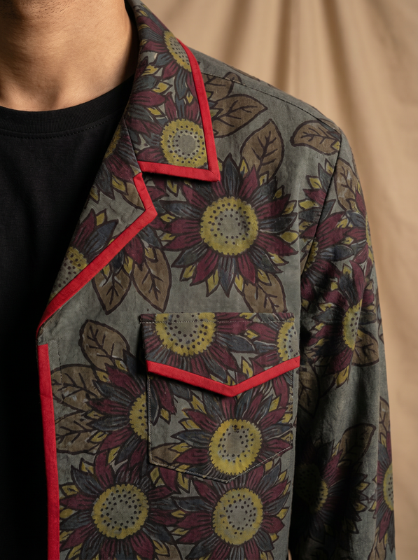 Boys olive grey sunflower shacket — close-up of dark botanical print and red piping detail