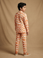 Boy wearing orange white ikat ikat chevron print cotton heritage co-ord set back view | NEW AGE CLOTHING