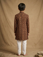 Boy wearing black red hand block printed indo western kurta with off-white pajama back view