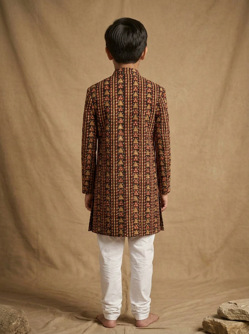 Boy wearing black red hand block printed indo western kurta with off-white pajama back view