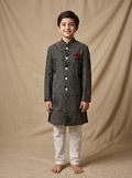 Boy wearing charcoal black machine embroidered floral vine cotton indo western kurta with off-white pajama front view