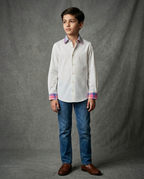Boy wearing off white cotton shirt with contrast multicolour plaid collar and cuffs front view
