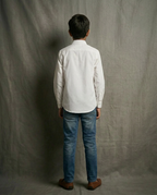 Boy wearing white cotton shirt with contrast blue bib panel and mandarin collar back view