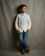 Boy wearing white cotton shirt with contrast blue bib panel and mandarin collar front view
