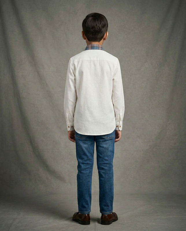 Boy wearing white cotton shirt with contrast blue brown tartan plaid bib panel and mandarin collar back view