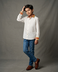 Boy wearing white cotton shirt with contrast mustard floral printed collar and cuffs front view