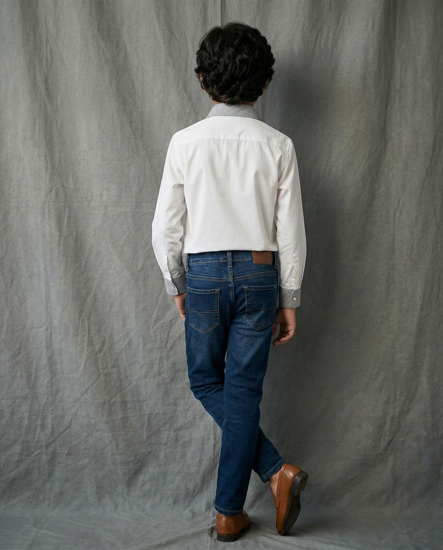 Boy wearing white cotton shirt with contrast charcoal grey striped collar and cuffs back view