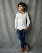 Boy wearing white cotton shirt with contrast charcoal grey striped collar and cuffs front view