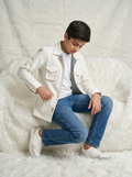 Boy wearing off white premium cotton casual jacket with gingham check inner facing detail and quad flap pockets front view